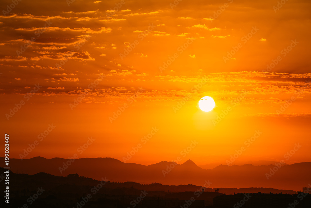 Sunset Sunrise Over Dark Mountain Silhouette. Yellow And Orange 