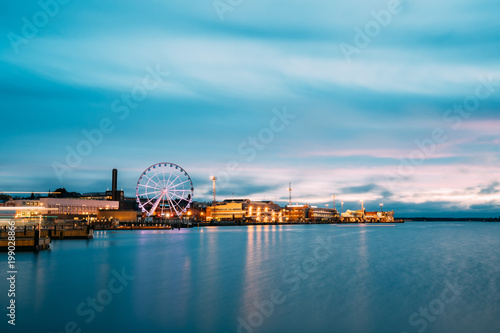Helsinki, Finland. View Of Embankment With Ferris Wheel In Evening