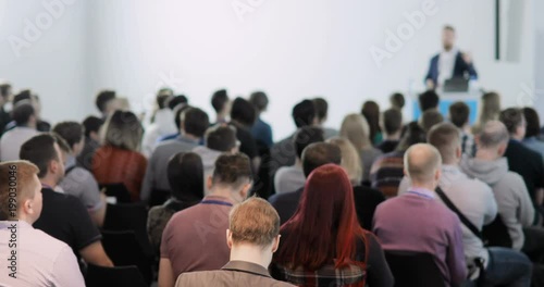 people at a conference. They talk about modern technologies and IT. Problems of digital security, IT people. Listen to the speaker