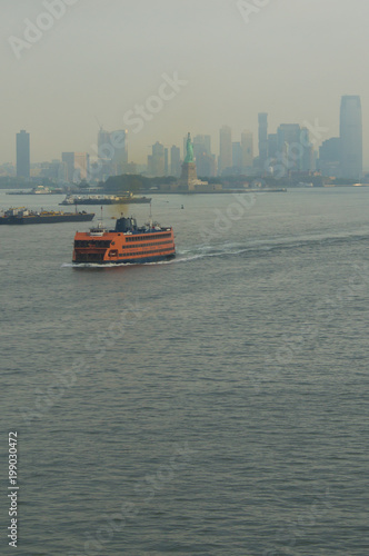 The staten island ferry in front of the Statue of Liberty