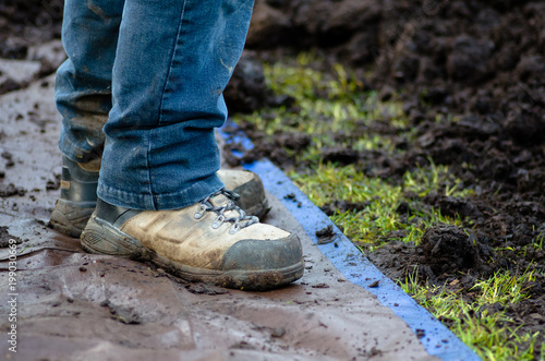 Closeup of work boots on tarp
