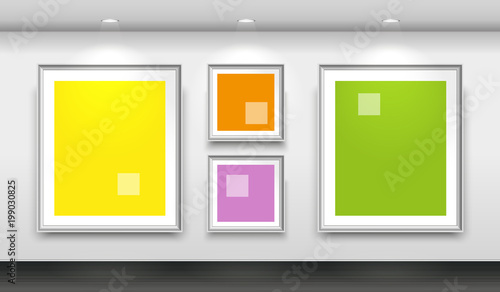 Interior gallery with four empty white frames on the wall