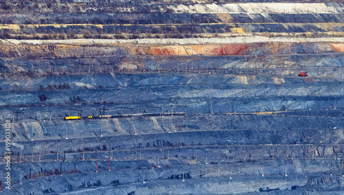 The Ground layers in the open pit with a train carrying the breed photo