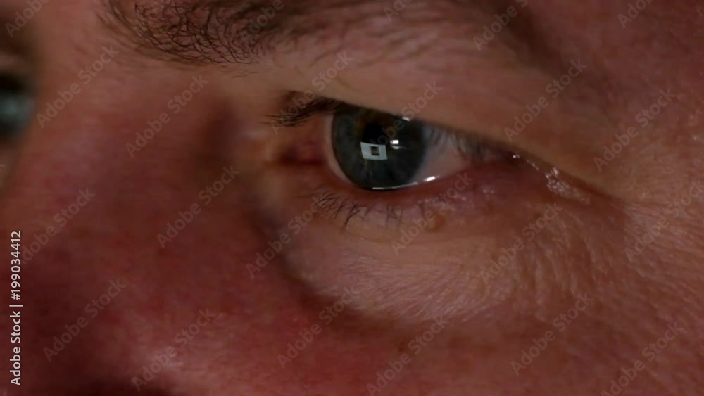Man Browsing Internet at night. Monitor reflects on his eyes Man Browsing Internet at night. Monitor reflects on his eyes
