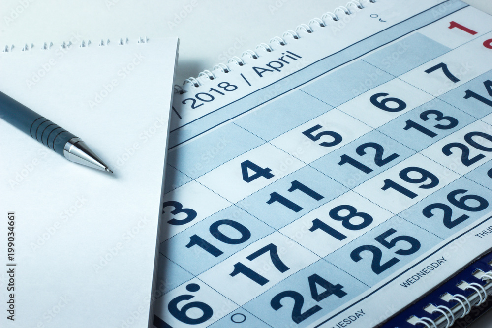 sheet of a calendar and a pen close-up sheet of a calendar and a pen close-up