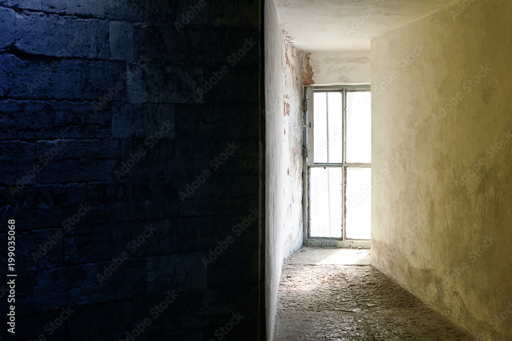 Bright window in the dungeon or in the bunker. Image divided into two halves Bright window in the dungeon or in the bunker. Image divided into two halves