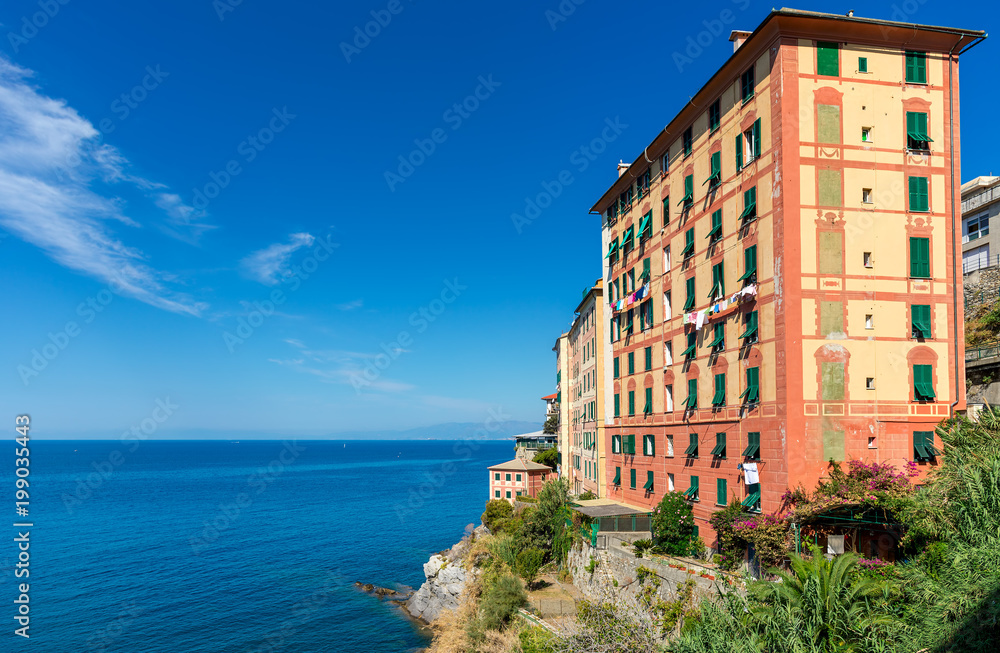 Colorful building overlooking Mediterranean sea in Italy.