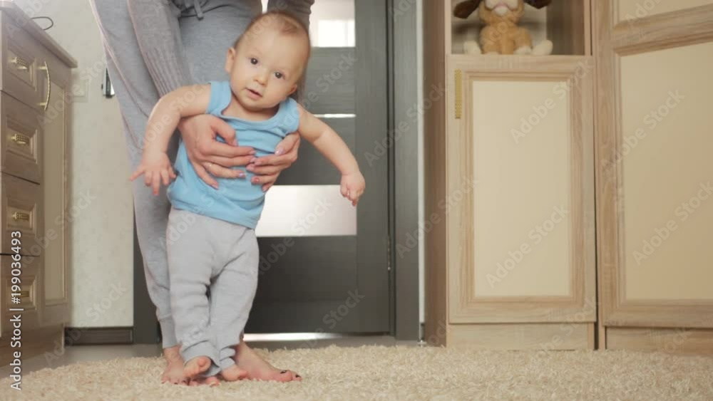 baby taking first steps with mother help baby taking first steps with mother help