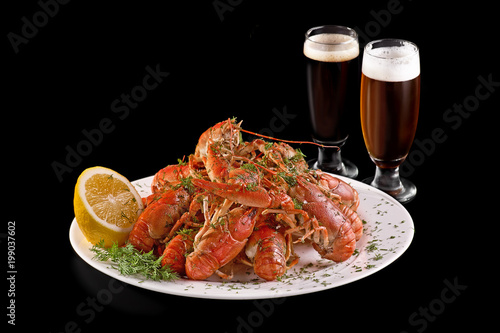 Crawfish. Boiled red crayfish or crawfish with a beer and herbs on a slate table. Close up. Crayfish party, restaurant, pub menu