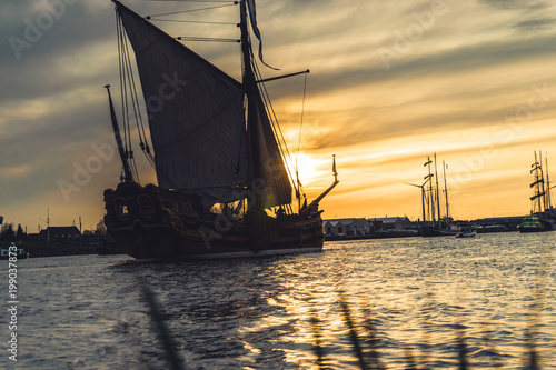 Фотография Historic sailboats in the rays of the setting sun