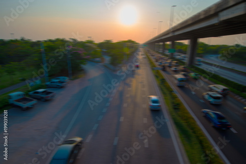 Blurry images of cars speeding on the road. © yongyut