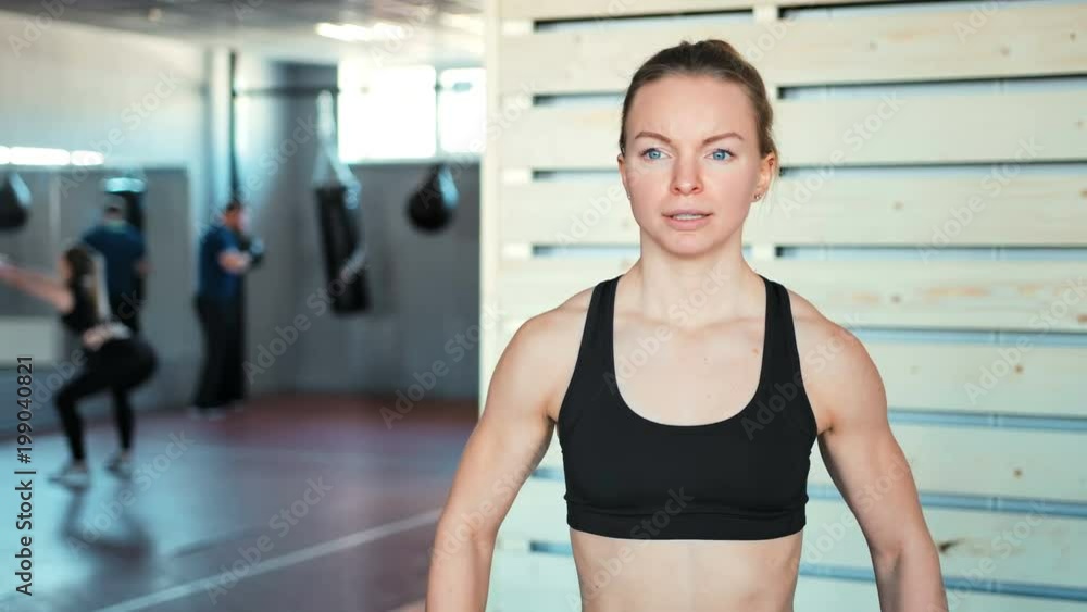 Fitness girl lifting dumbbell in the gym Fitness girl lifting dumbbell in the gym