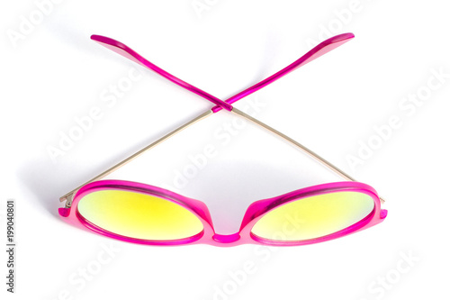 Pink sunglasses isolated on white background. The view from the top