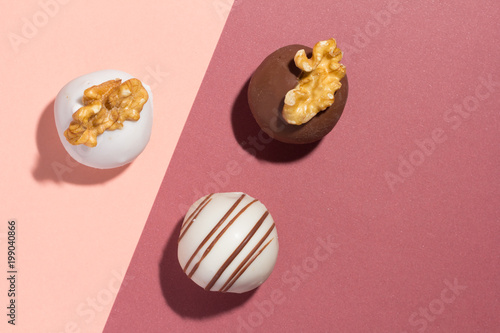 Assorted homemade chocolate truffles. Flat design of candy ball on color background.