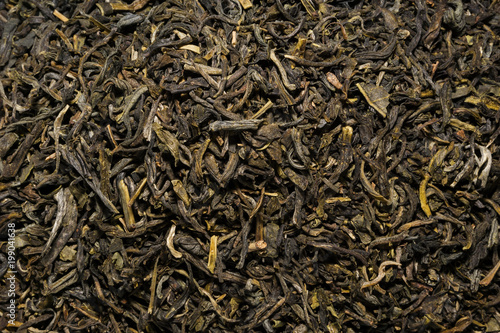 Dry leaves of green tea background texture, heap of dried leaves Chinese green teas with primiems