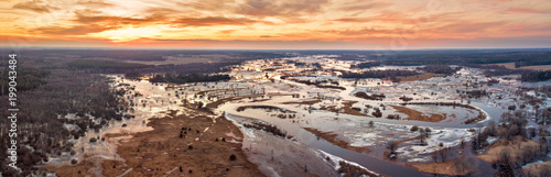 Obraz na płótnie Spring melting river flood panorama. Sunset over meadows w salonie