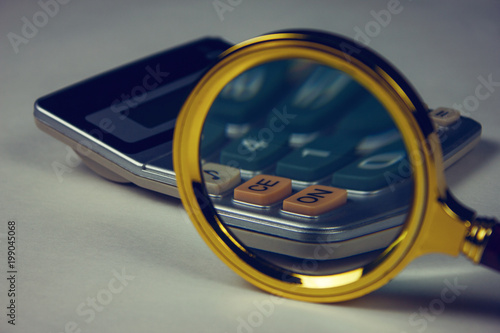magnifying glass and calculator