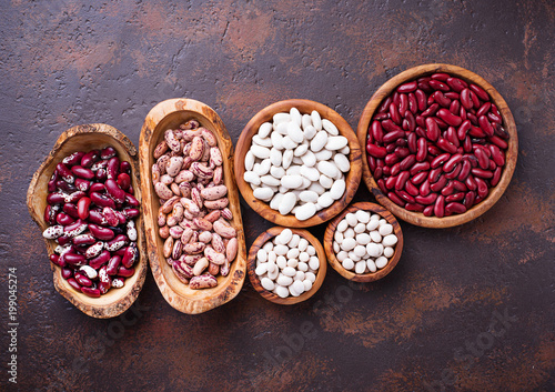 Assortment of various beans in wooden bowls