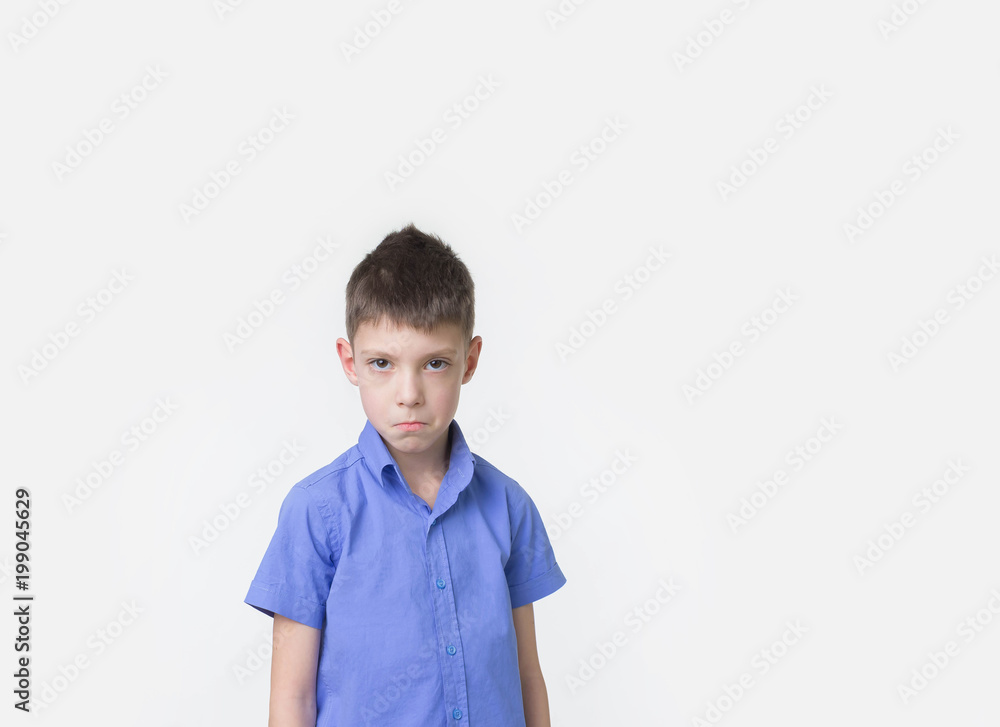 Handsome eight year old boy posing in studio over white background. Handsome eight year old boy posing in studio over white background.