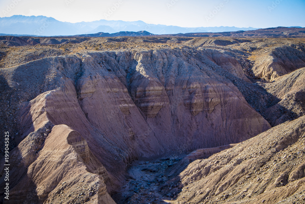 Canyons Showing Pink Sedimentary Strata Leading into a Dusty Wash in the Anza Borrego Desert State Park