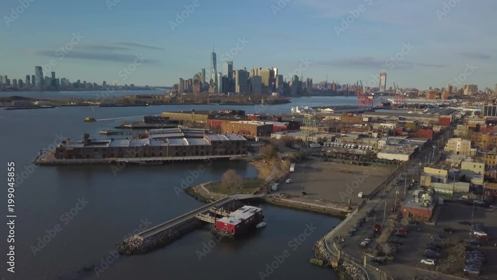 alt day flying over Red Hook waterfront towards Manhattan skyline alt day flying over Red Hook waterfront towards Manhattan skyline