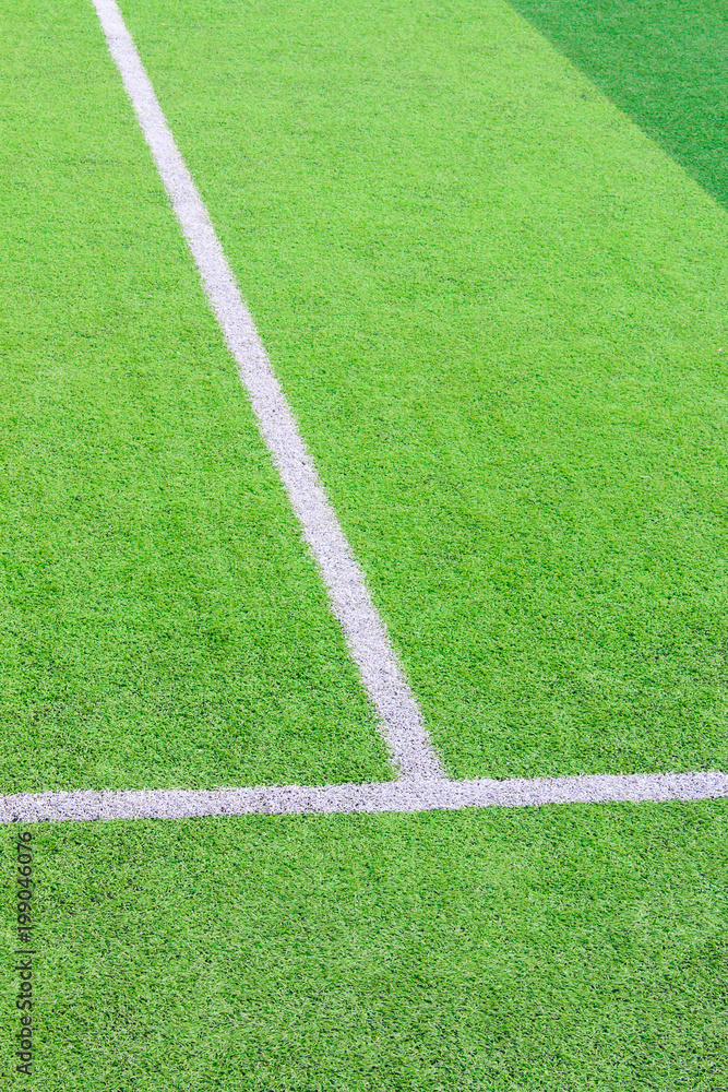 The white Line marking on the artificial green grass soccer field