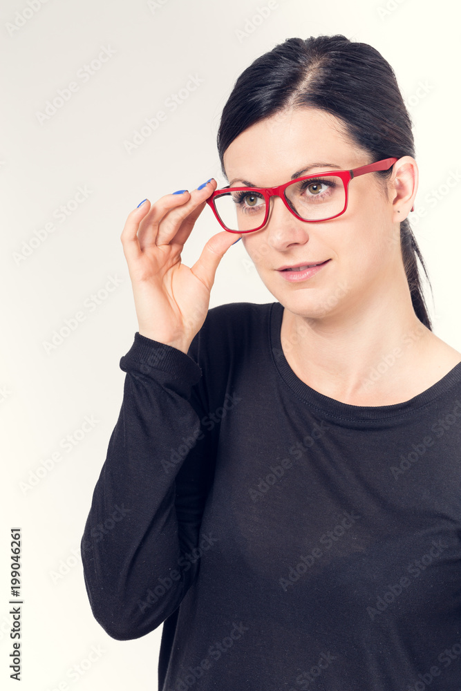 Portrait of a young woman with black hair and red glasses. Portrait of a young woman with black hair and red glasses.