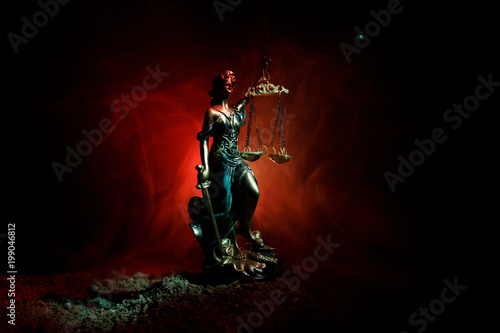 The Statue of Justice - lady justice or Iustitia / Justitia the Roman goddess of Justice on a dark fire background