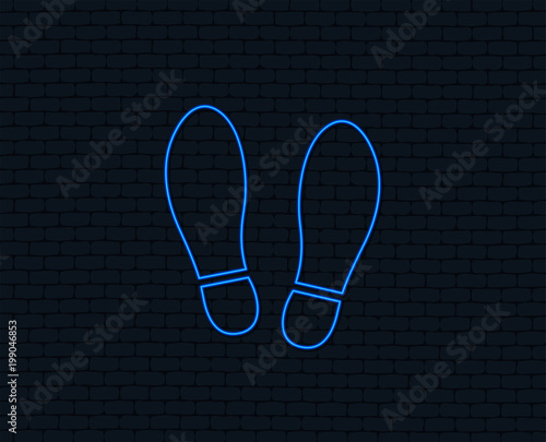 Neon light. Imprint soles shoes sign icon. Shoe print symbol. Glowing graphic design. Brick wall. Vector