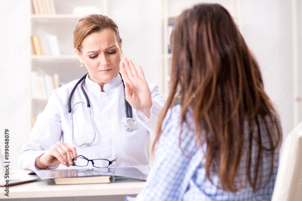 Pregnant woman visiting doctor for regular check-up Pregnant woman visiting doctor for regular check-up