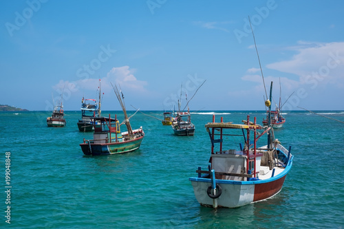 Several traditional local boats to catch fish in Weligama Bay. Fishing indusrty in Sri Lanka