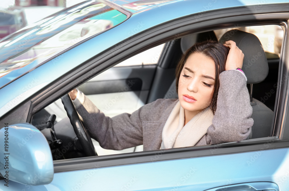 Young woman in car during traffic jam