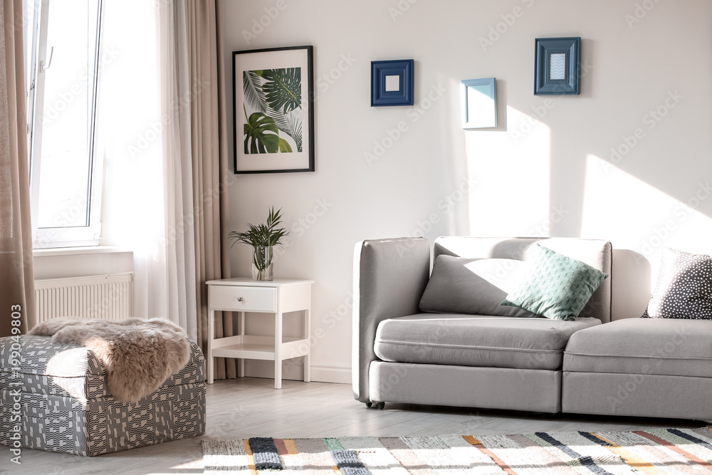 Fototapeta premium Stylish living room interior with comfortable sofa