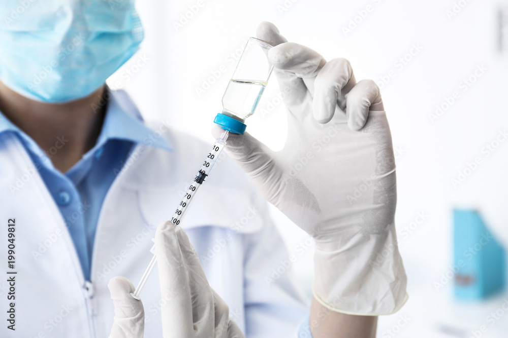 Female doctor with vial and syringe in hospital. Vaccination day Female doctor with vial and syringe in hospital. Vaccination day