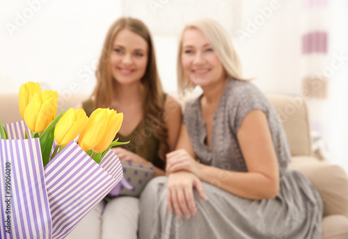 Congratulating happy women with holiday at home
