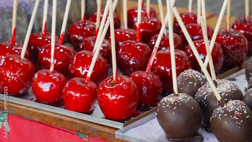 Caramel apples in chocolate and nuts. Street food photo