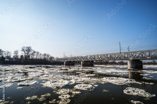 bridge over a snow covered river © lakkot