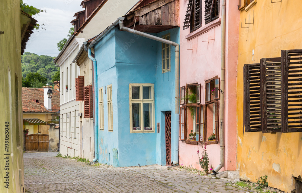 Colorful cobblestoned street in Sighisoara, Romania