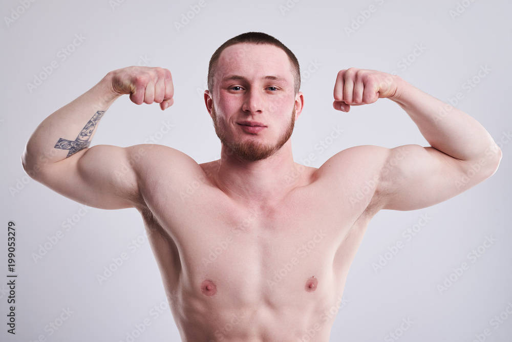 closeup ogf young strong man showing his biceps closeup ogf young strong man showing his biceps