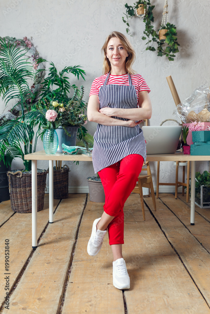 Picture of florist in apron with crossed hands Picture of florist in apron with crossed hands