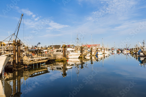 fishing boats and boats on the pier in the summer noon