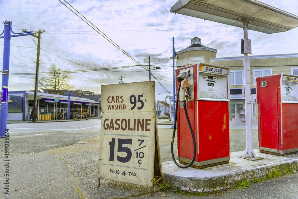 Fototapeta premium old gas station, at the corner of the streets of the old city, with old gasoline prices