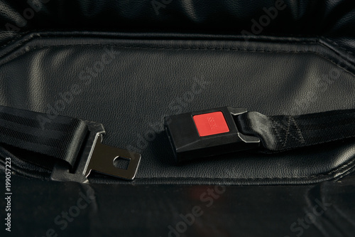 Seat belt on black car leather seat, close-up. Safety concept