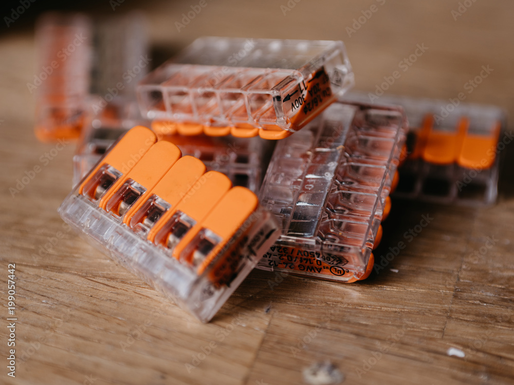 Modern AWG connectors on wooden background Modern AWG connectors on wooden background