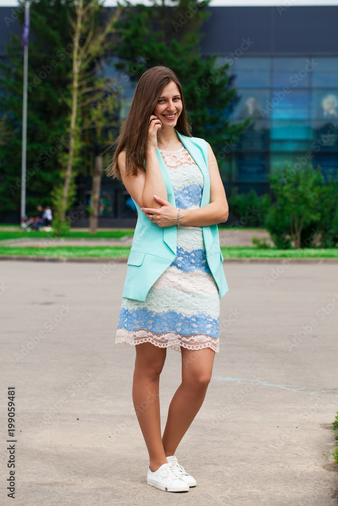 Beautiful brunette woman in summer dress on the street Beautiful brunette woman in summer dress on the street
