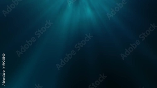 Deep Underwater Light Rays. Abstract light rays of sunshine through a soft blue-green background with a solemn and lonely feeling of being deep under water.