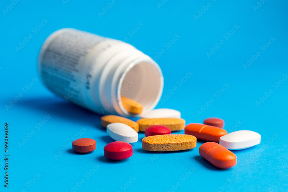 Assorted pharmaceutical medicine pills on blue background Assorted pharmaceutical medicine pills on blue background