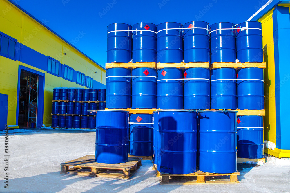 Chemical reagents. The blue barrels stand on pallets. Chemical industry