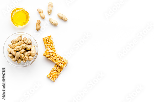 Energy protein snacks with peanuts on white background top view copy space