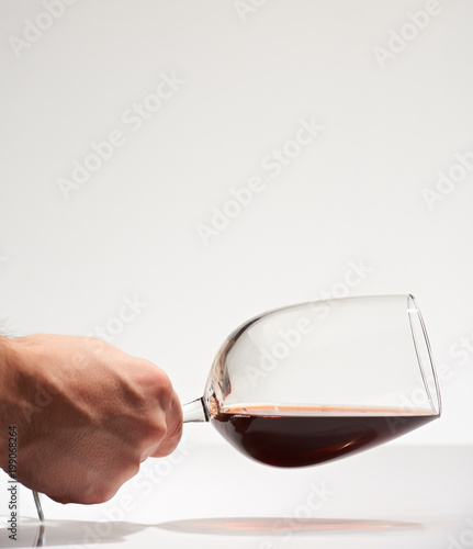 Hand hold horizontal red wine glass